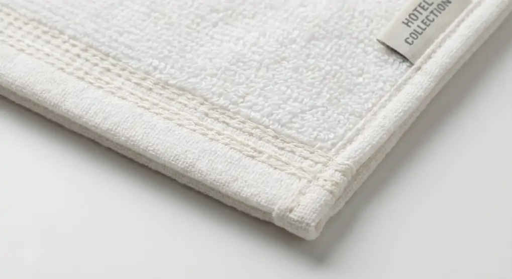 Close-up view of double-needle stitching on hotel towel edge