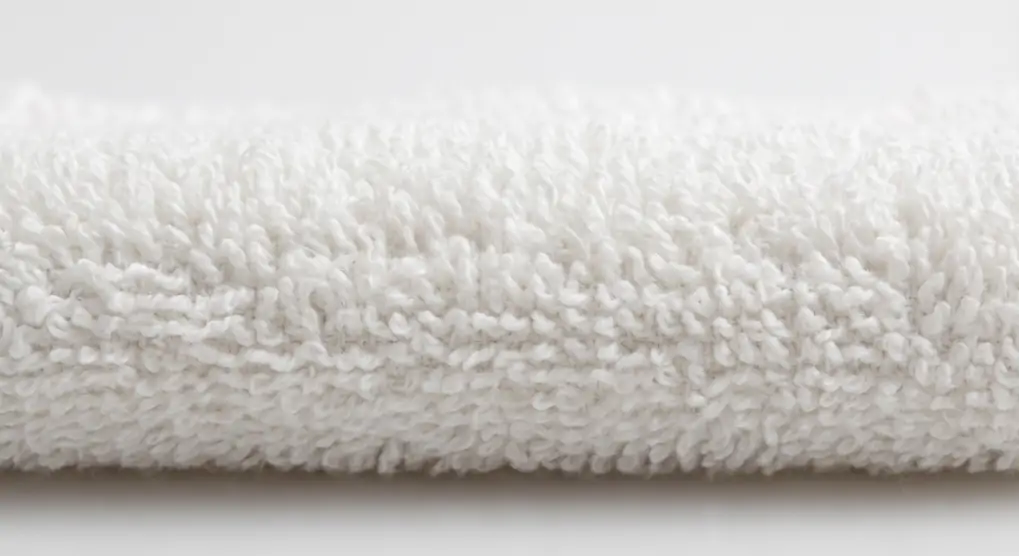 Macro detail of 600 GSM hotel towel fabric showing terry loop density and pile height