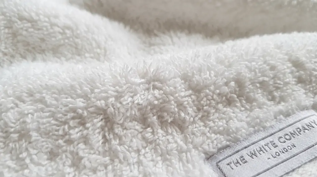 Close-up of luxurious plush cotton bath towel texture showing looped pile surface